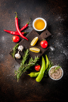 Food cooking ingredient, olive oil, herbs and spices, dark rusty background top view copy space