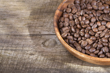 Roasted coffee on the wooden background - Coffea