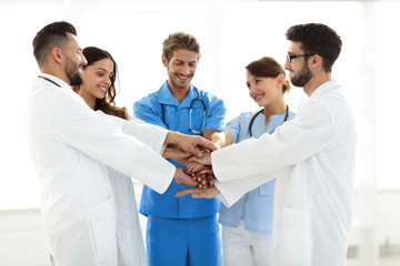 Fototapeta premium Doctors and nurses stacking hands. concept of mutual aid.