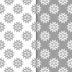 White and gray floral backgrounds. Set of seamless patterns