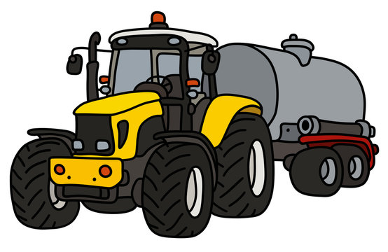 The yellow heavy tractor with a steel tank trailer