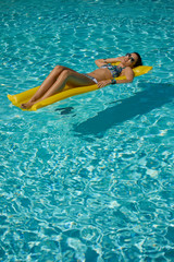 Woman relaxing in a pool