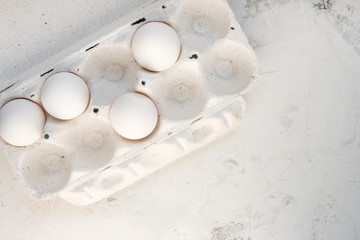 Eggs in a special box. Four white eggs