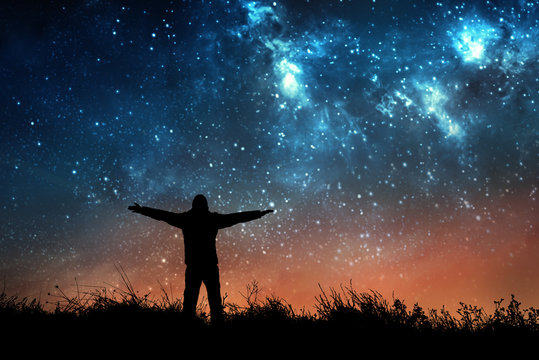 man watching the stars in night sky