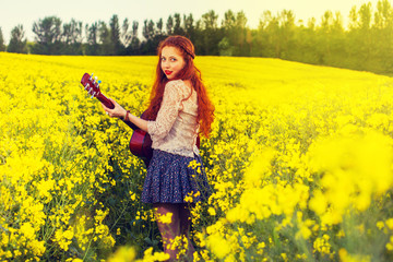 Fototapeta premium Young ginger hair girl in 70s style with acoustic guitar
