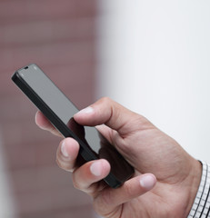 closeup.a man holds a smartphone.
