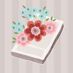 A bouquet of pink and blue flowers lies on the book. Illustration on a striped background