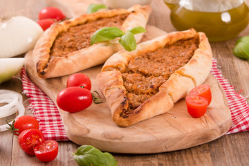 Turkish pide pizza with meat and onion.