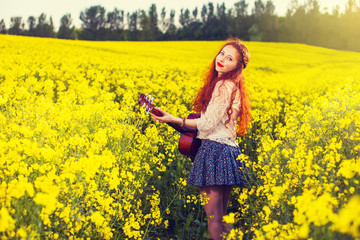 Fototapeta premium Young ginger hair girl in 70s style with acoustic guitar