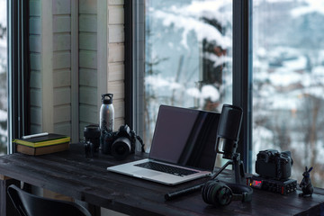 Audio / Video editing workspace office with mountain view. Photography and videography equipment.