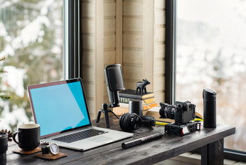 Audio / Video editing workspace office with mountain view. Photography and videography equipment.