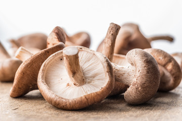 Shiitake mushrooms on the wooden background.