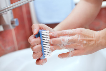 Washing hands and cleaning nails with brush