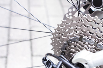 Bicycle gear and disk brake detail, close up shot of new and clean silver mountainbike metal chain rings