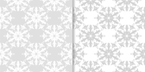 Light gray floral backgrounds. Set of seamless patterns