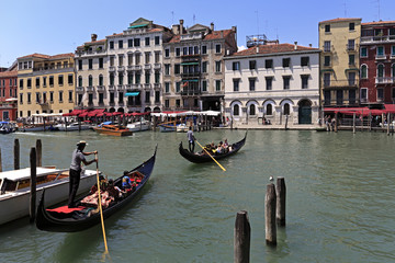Venice historic city center, Veneto rigion, Italy - view on the Palazzo residence buildings, vaporetto water taxis and gondolas by the Grand Canal