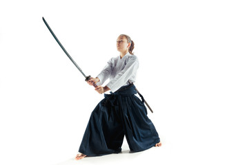 Aikido master practices defense posture. Healthy lifestyle and sports concept. Woman in white...
