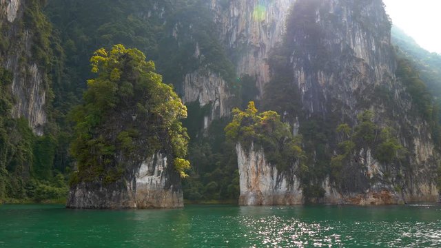 View from the water at the famous "Three Sisters" karst formations in Cheow Lan Lake inside Khao Sok National Park, Thailand
