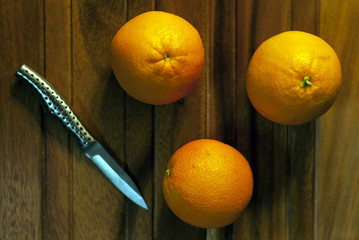 Delicious Sweet Whole Oranges On Wood Table With Cutting Knife