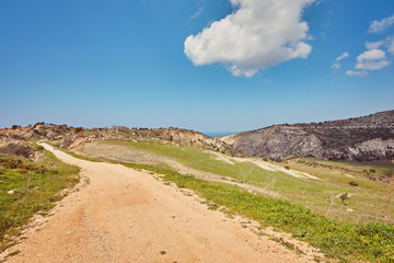 Sunny vanishing footpath among sunny growth on Avakas Gorge slopes.