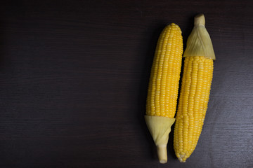 Corn on wood background.