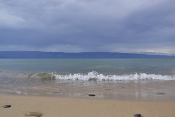 Baikal Wave crystal clear water before the storm on the background of a stormy sky infinite number of shades of blue Olkhon Island, the city of Irkutsk, Khuzhir