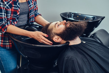 Handsome bearded man in the barbershop.