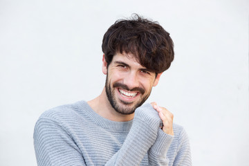 Fototapeta premium Close up attractive young man with beard laughing in front of white background