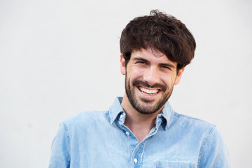 Obraz premium Close up smiling young man with beard against white background