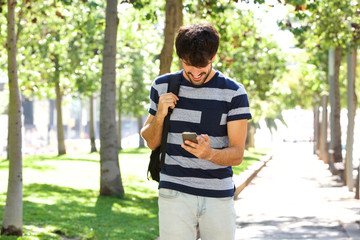 young man looking at mobile phone in park