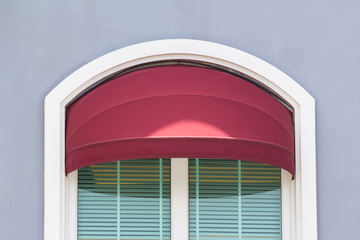 red curve awning over glass window of  cafe shop