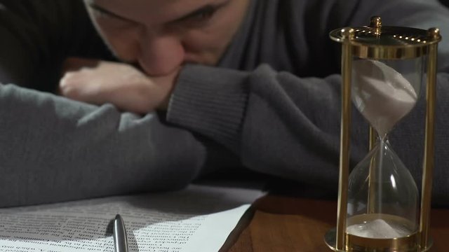 Young man thinking about signing document, starting new business, close-up