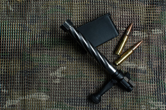 Shutter, carbine clip, ammo, lies  and on a multicam pattern background.