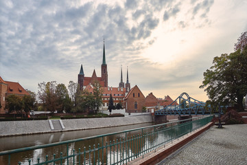 Naklejka premium Wroclaw Old Town. Cathedral Island (Ostrow Tumski) is the oldest part of the city at the sunset. Cathedral of St. John and Odra (Oder) river Tumski bridge
