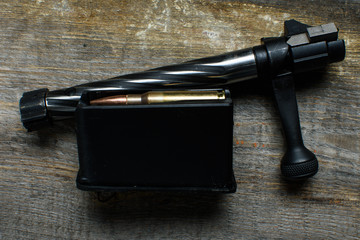 Shutter, carbine clip, ammo, lies  and on a wooden background.