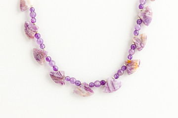 close up of a lavendar necklace constructed with several sizes of beads