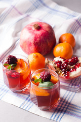 portioned fruit dessert in glass cups kremankah - jelly with fruit and mint, low-calorie summer snack
