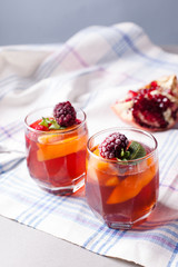portioned fruit dessert in glass cups kremankah - jelly with fruit and mint, low-calorie summer snack
