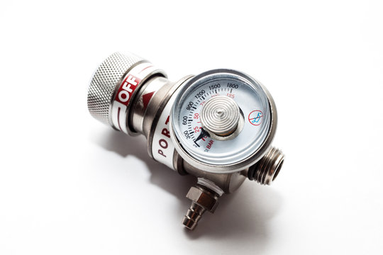 portable gas cylinder valve with monitor pressure gauge on white background.