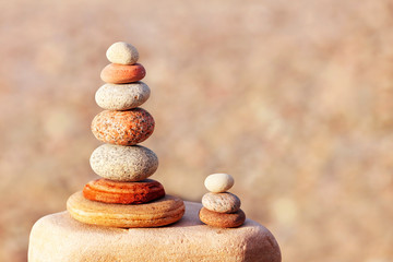 Fototapeta na wymiar Rock zen pyramid of white, red and yellow stones. Concept of balance, harmony and meditation