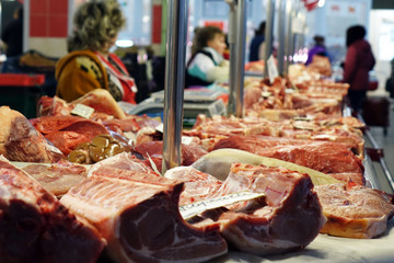 Pieces of fresh beef lying on the counter on the market.
