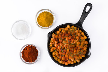Fried spicy chickpeas in frying pan isolated on white background