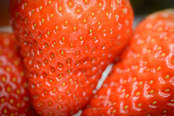 Natural looking fresh red strawberry. Macro with shallow depth of field.