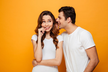 Pleased woman standing near the her boyfriend which talking something