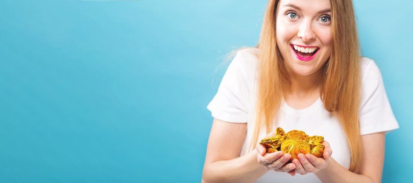 Woman with her hands full of bitcoin