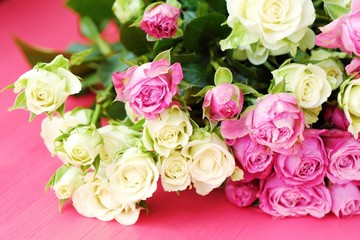 Beautiful bouquet of white and pink roses on pink background  