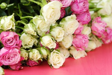 Beautiful bouquet of white and pink roses on pink background  