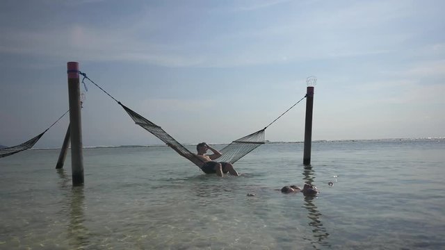 Young couple enjoys a beautiful afternoon in the ocean