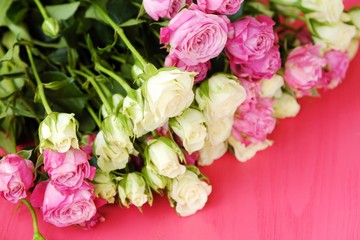 Beautiful bouquet of white and pink roses on pink background  