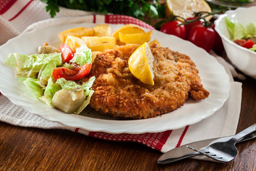 Breaded viennese schnitzel with baked potatoes